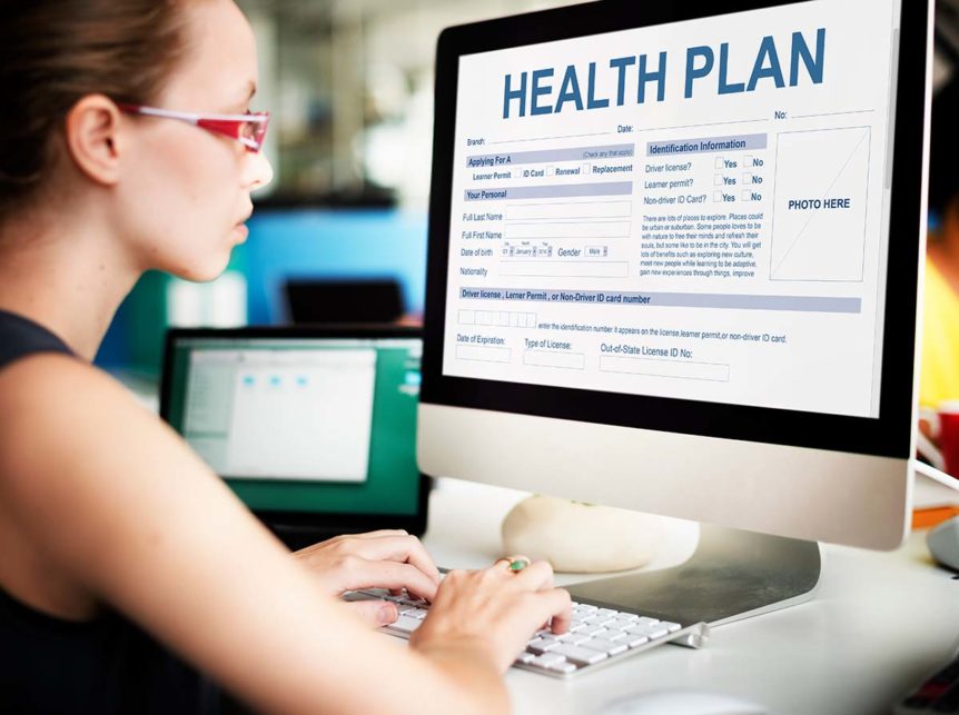 manager on computer researching the importance of healthcare benefits