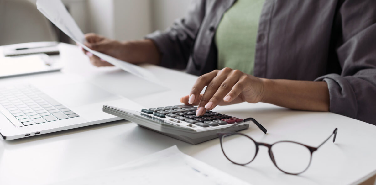 diverse person using calculator